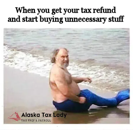 Man in a mermaid tail on a beach: When you get your tax refund and start buying unnecessary stuff
